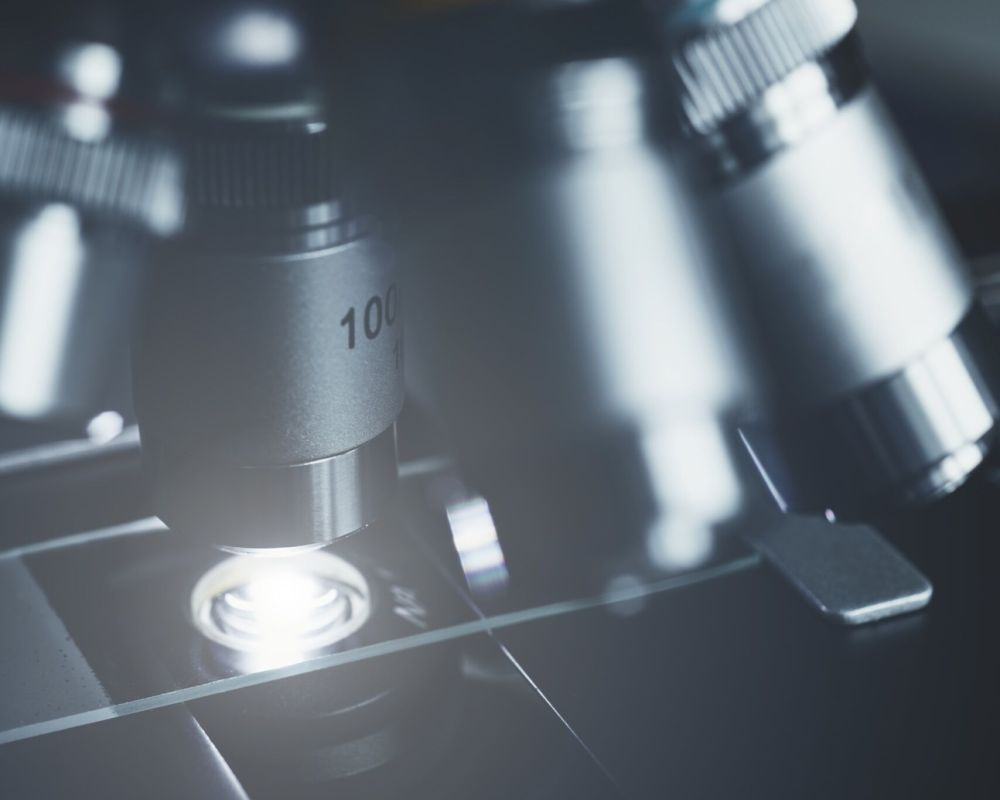 Close-up shot of modern microscope with sample slide at laboratory.